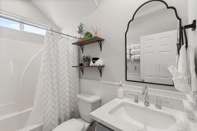 full bathroom with vanity, vaulted ceiling, toilet, ornamental molding, and shower / tub combo with curtain