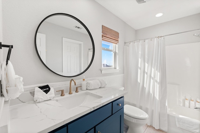 full bathroom featuring vanity, shower / bath combination with curtain, and toilet