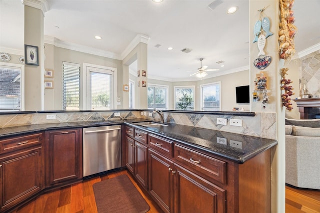 kitchen featuring ceiling fan, dishwasher, sink, dark wood-type flooring, and kitchen peninsula