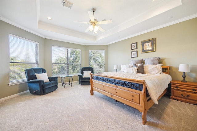 bedroom featuring carpet floors, a tray ceiling, ceiling fan, and crown molding