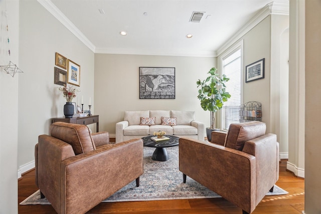 living room with light wood-type flooring and ornamental molding