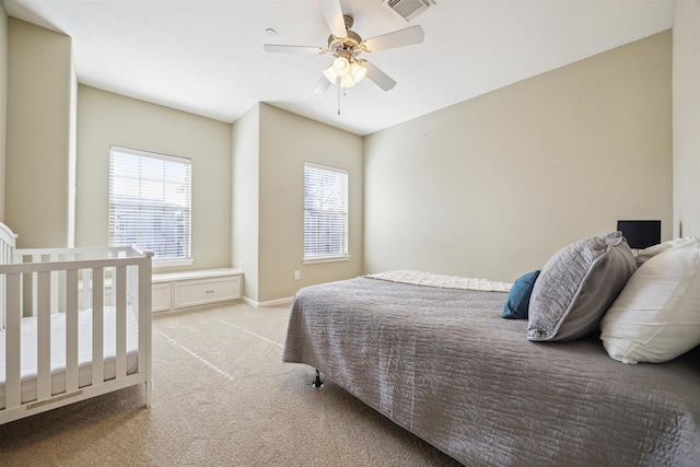 bedroom with ceiling fan and light colored carpet