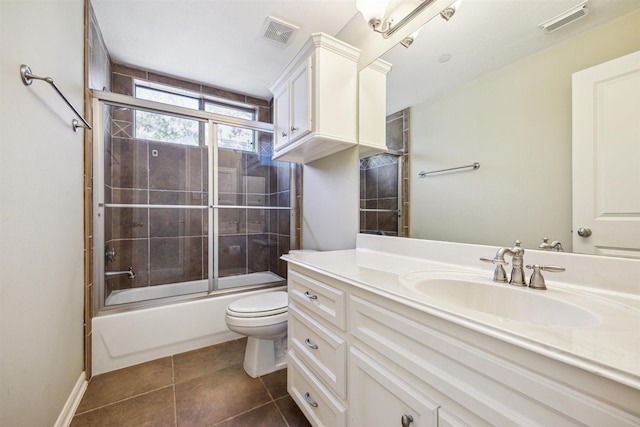 full bathroom with tile patterned floors, vanity, enclosed tub / shower combo, and toilet