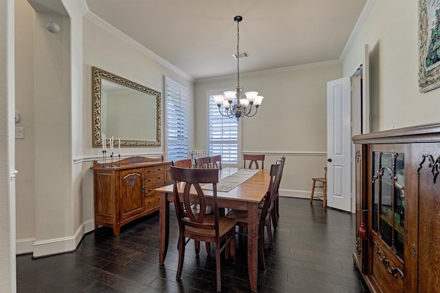 dining area featuring dark hardwood / wood-style floors, ornamental molding, and a chandelier