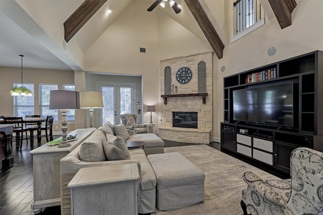 living room with hardwood / wood-style flooring, ceiling fan, a fireplace, and high vaulted ceiling