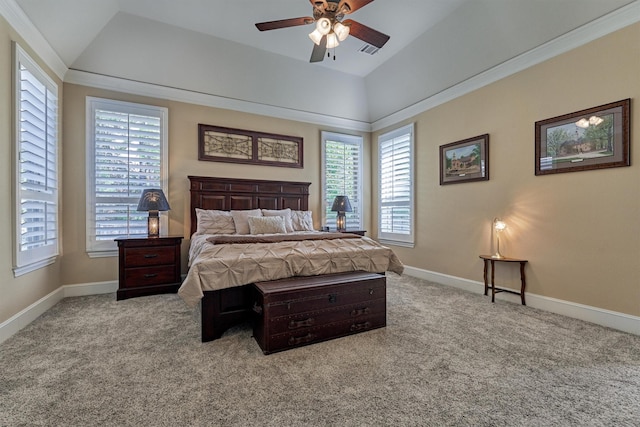 bedroom with light colored carpet, vaulted ceiling, ceiling fan, and a tray ceiling