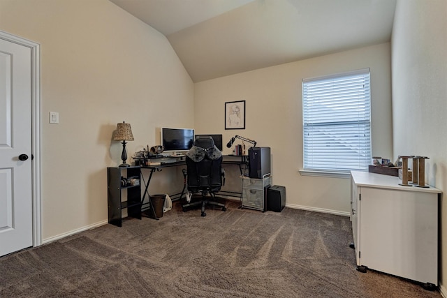 office with dark carpet and vaulted ceiling