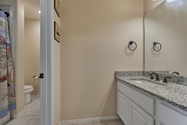 bathroom featuring tile patterned floors, vanity, and toilet