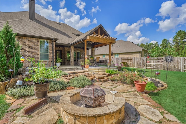 view of patio with a pergola and a fire pit