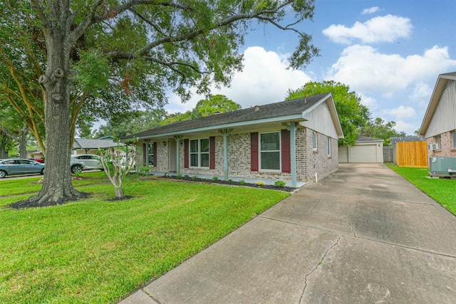 ranch-style house with an outdoor structure, a garage, central air condition unit, and a front lawn