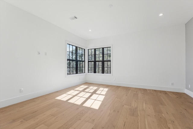 spare room featuring light hardwood / wood-style floors