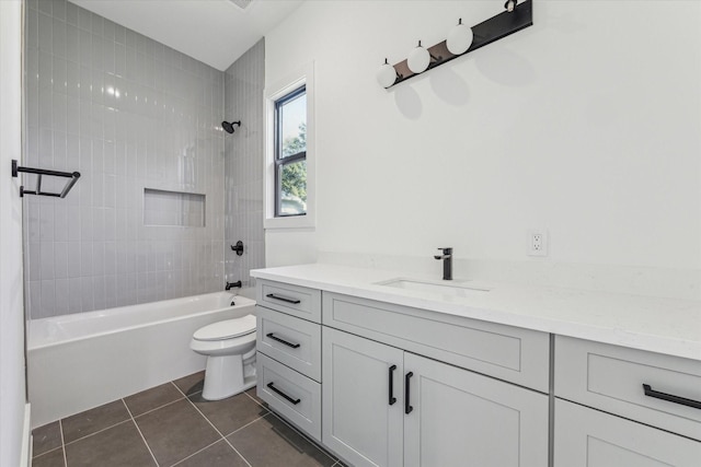 full bathroom featuring tile patterned flooring, vanity, toilet, and tiled shower / bath