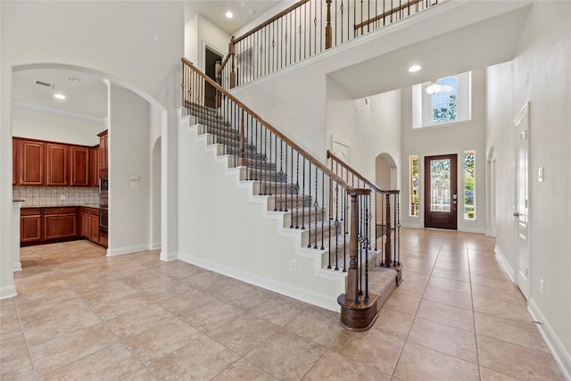 tiled entryway featuring a high ceiling