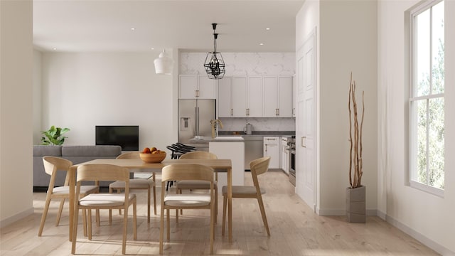 dining space featuring light hardwood / wood-style flooring and sink