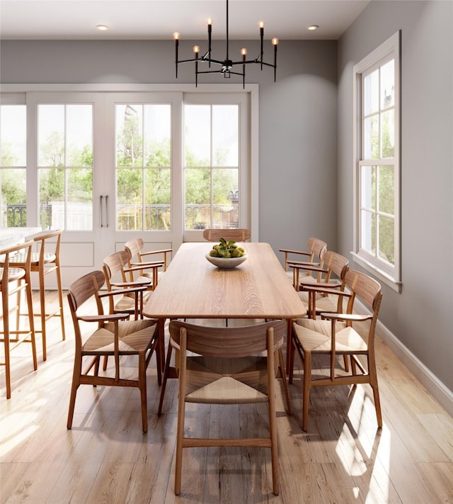 dining area featuring light hardwood / wood-style flooring and an inviting chandelier