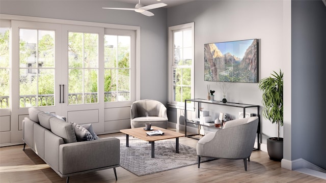 sitting room with light wood-type flooring and ceiling fan