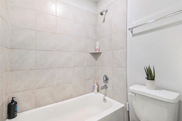 bathroom featuring toilet and tiled shower / bath