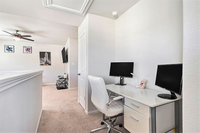 carpeted office space featuring ceiling fan