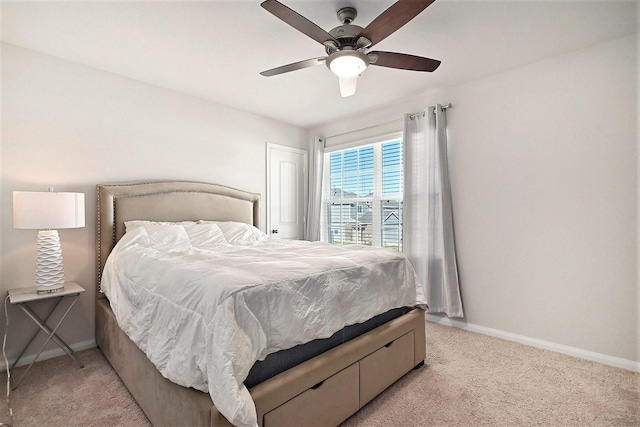 bedroom with ceiling fan and light carpet