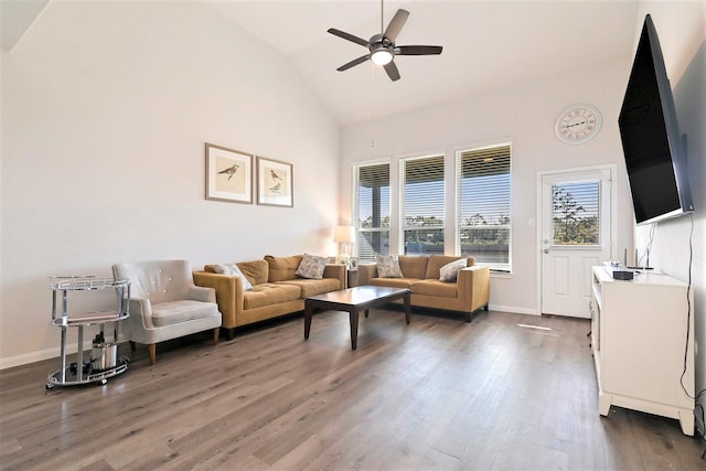 living room with ceiling fan, dark wood-type flooring, and vaulted ceiling