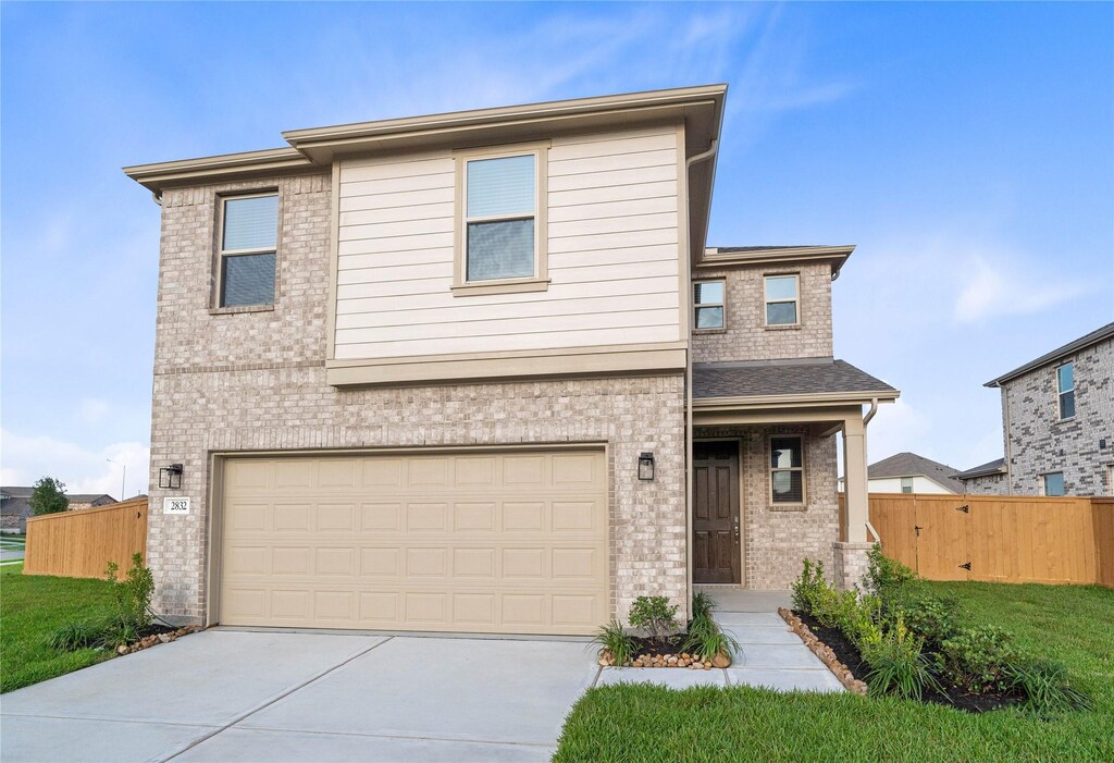 2832 Shimmer Edge Dr, Katy, TX 77493 - view of front of house featuring an attached garage, brick siding, and driveway