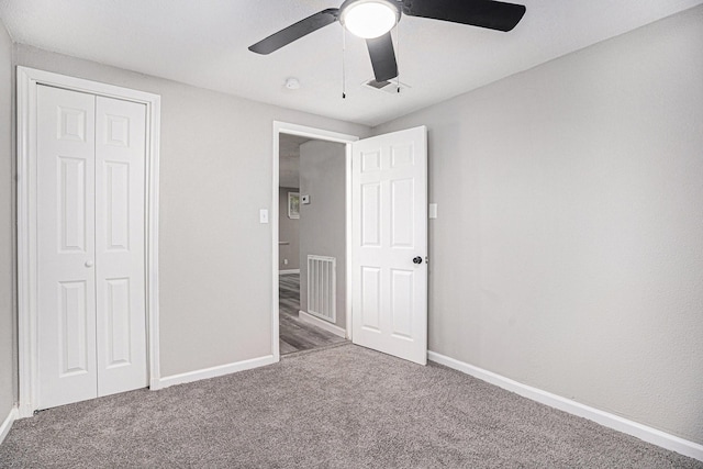 unfurnished bedroom featuring carpet, a closet, and ceiling fan