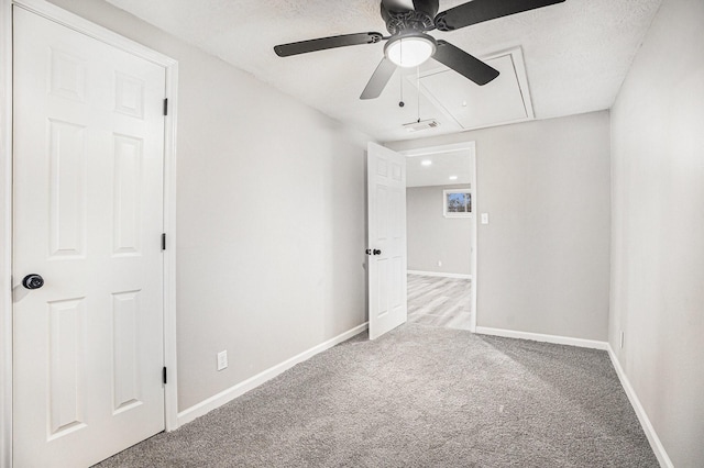 carpeted empty room featuring a textured ceiling and ceiling fan