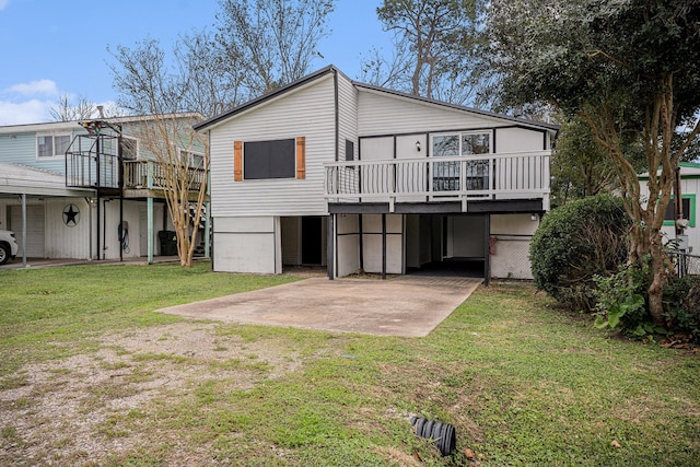 back of property with a deck and a lawn