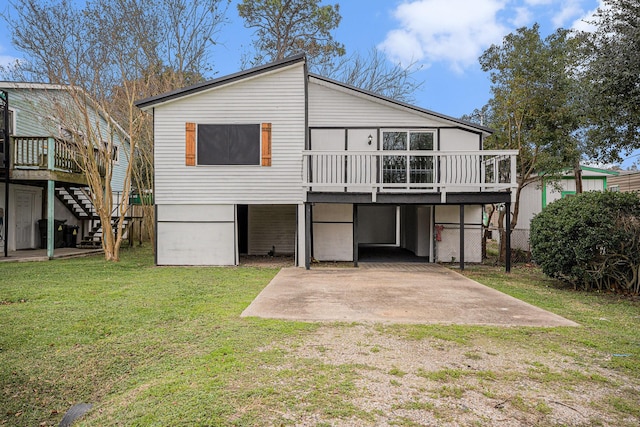 rear view of property featuring a patio area, a yard, and a deck