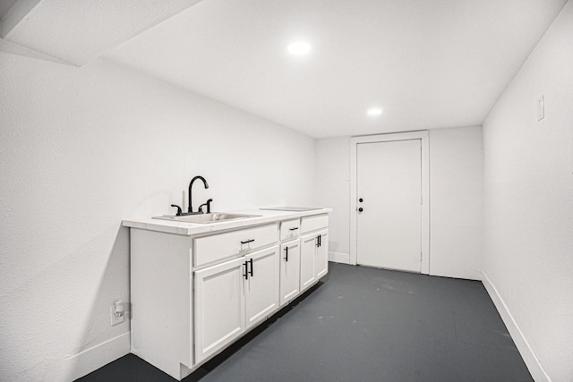 bar with white cabinets and sink