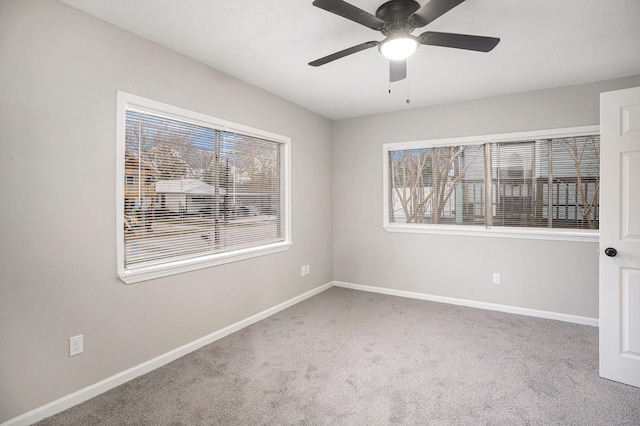 carpeted empty room featuring ceiling fan