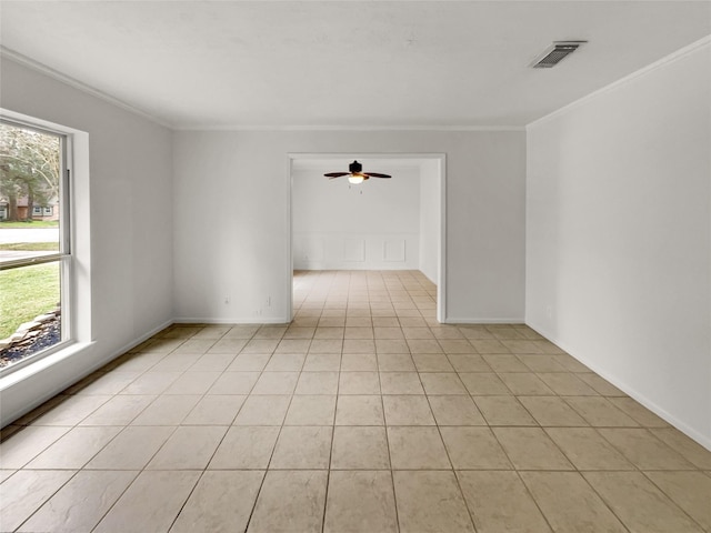 spare room featuring light tile patterned floors, ceiling fan, and crown molding