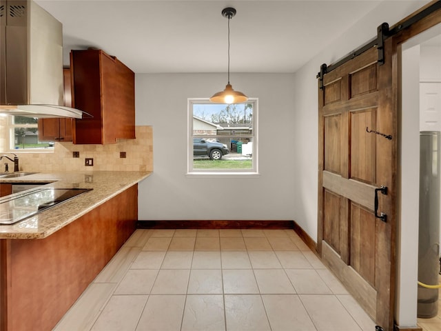 kitchen featuring tasteful backsplash, a barn door, island exhaust hood, decorative light fixtures, and black electric stovetop