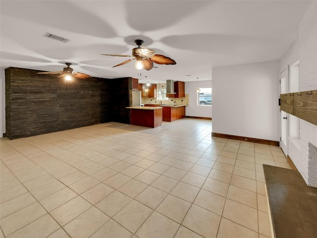 kitchen with a kitchen breakfast bar, light tile patterned floors, tasteful backsplash, white fridge, and kitchen peninsula