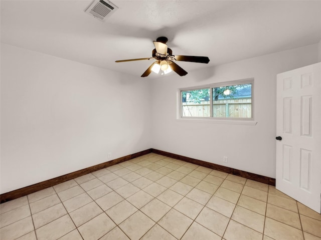 unfurnished room with light tile patterned floors and ceiling fan