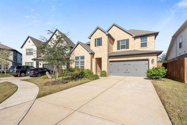 view of front of property featuring a front lawn and a garage