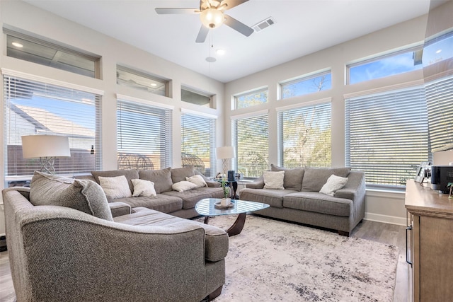 living room featuring ceiling fan and light hardwood / wood-style floors