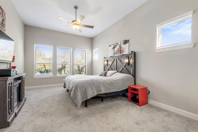 bedroom with ceiling fan and light carpet