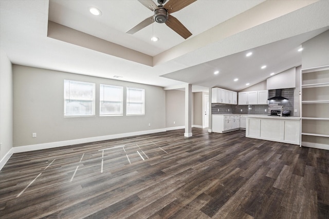 unfurnished living room featuring vaulted ceiling, ceiling fan, and dark wood-type flooring