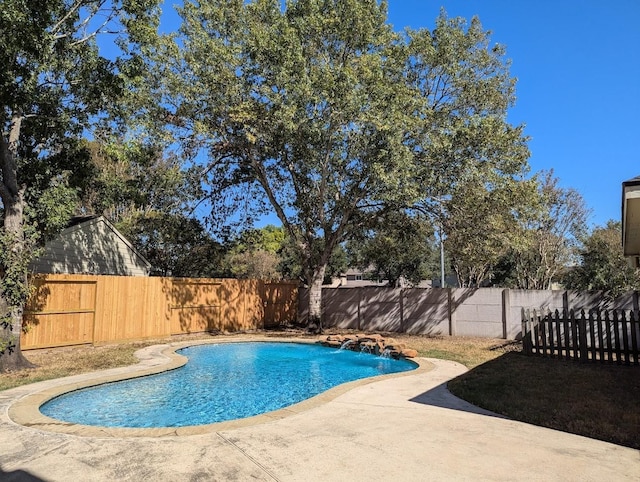 view of swimming pool featuring pool water feature and a patio area