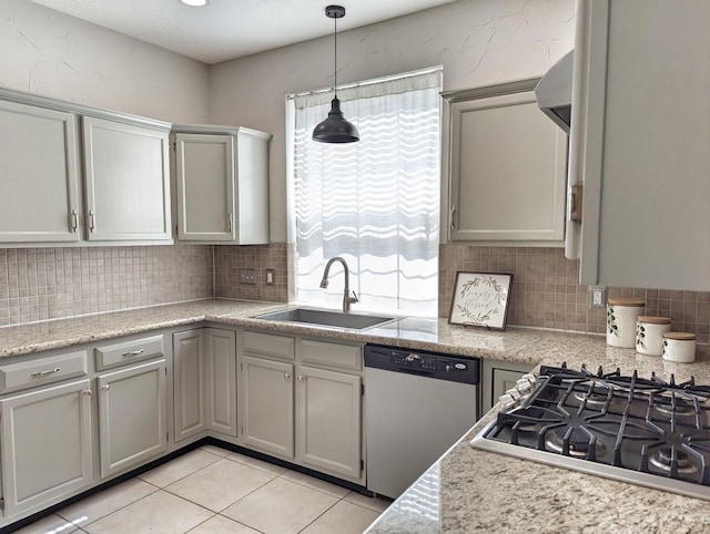 kitchen featuring light tile patterned flooring, appliances with stainless steel finishes, backsplash, and sink