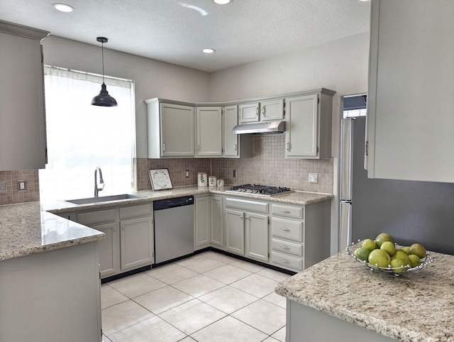 kitchen featuring a wealth of natural light, sink, light tile patterned floors, and appliances with stainless steel finishes