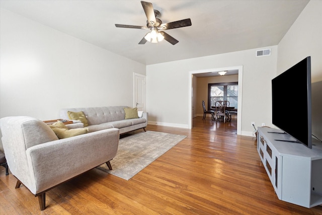 living room featuring ceiling fan and hardwood / wood-style floors