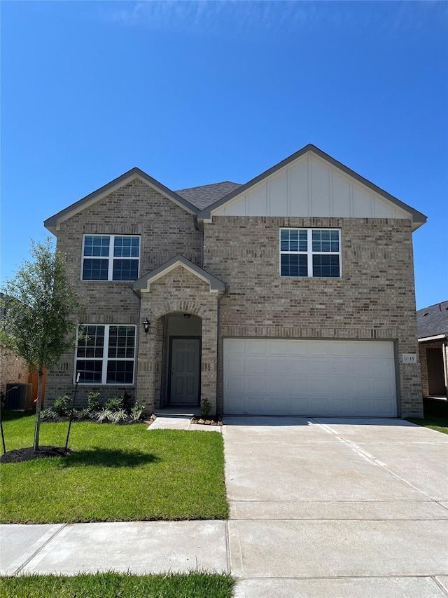 view of front of property with central AC, a garage, and a front lawn