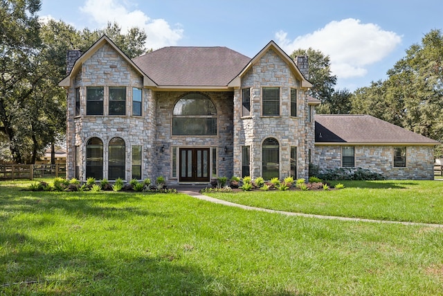 view of front of home featuring french doors and a front yard