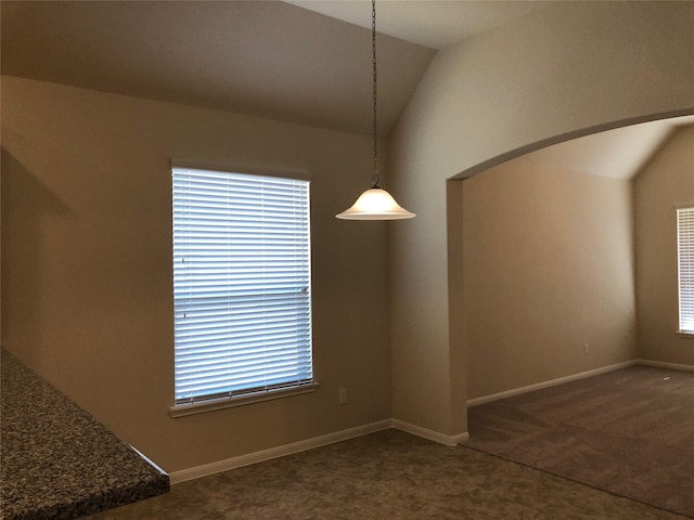 unfurnished dining area with lofted ceiling