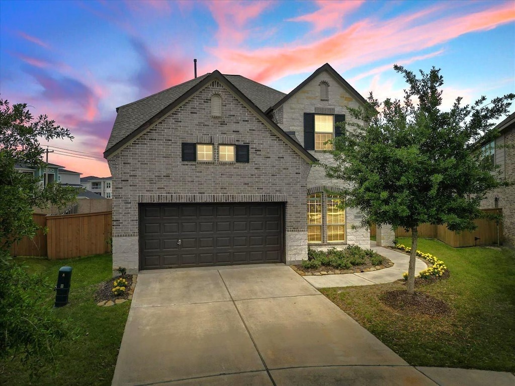 view of front of home featuring a yard and a garage