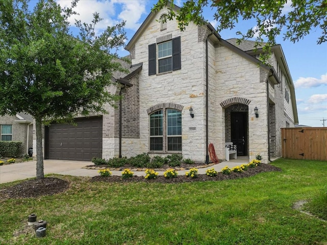 view of front facade featuring a garage and a front lawn