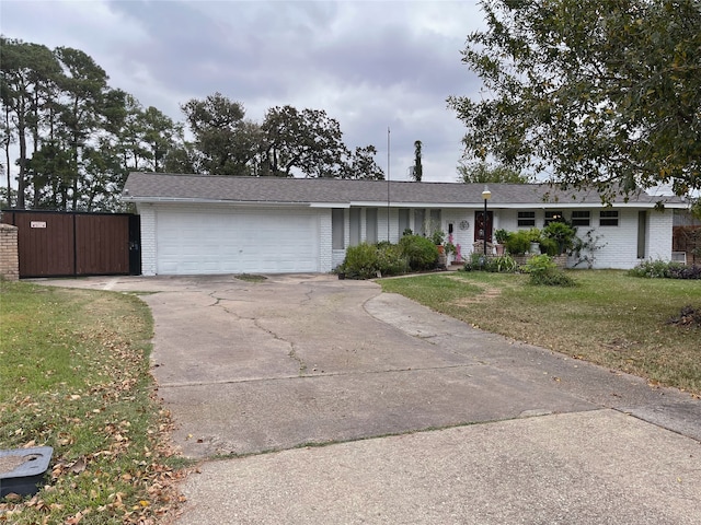 single story home with a garage and a front yard