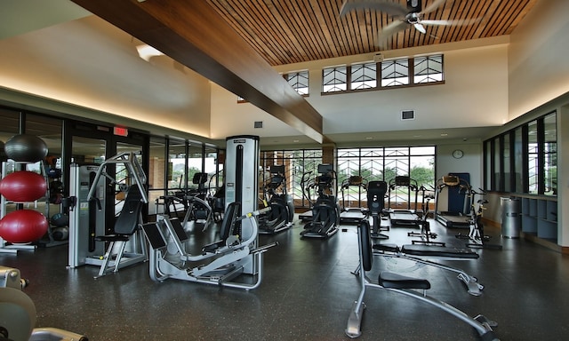 workout area with ceiling fan and a towering ceiling